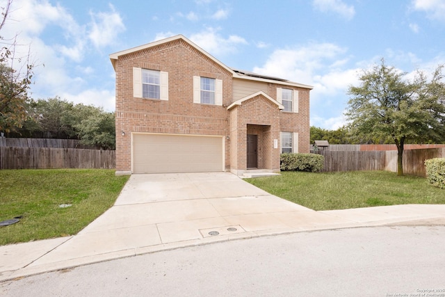 view of front property featuring solar panels, a front yard, and a garage