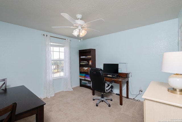 office area featuring light carpet and ceiling fan