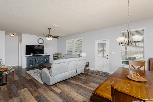 living room with plenty of natural light, dark hardwood / wood-style flooring, and a textured ceiling