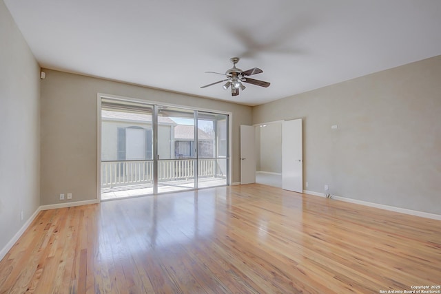 spare room with baseboards, a ceiling fan, and light wood-style floors