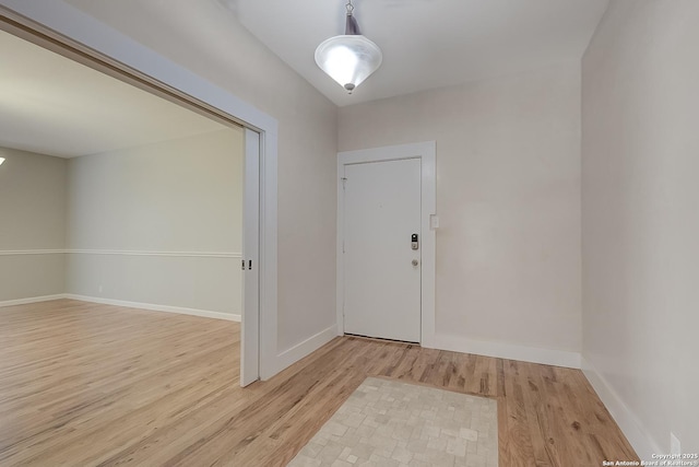 entryway with light wood-style floors and baseboards