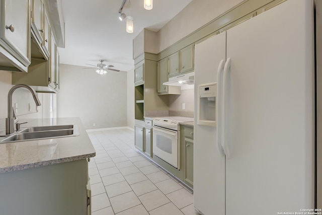 kitchen with white appliances, a ceiling fan, a sink, light countertops, and green cabinetry