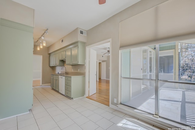 kitchen featuring light countertops, visible vents, a ceiling fan, a sink, and dishwasher