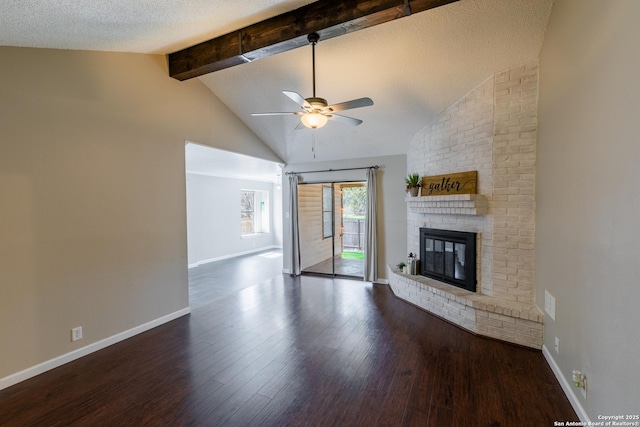 unfurnished living room with a fireplace, vaulted ceiling with beams, ceiling fan, a textured ceiling, and dark wood-type flooring