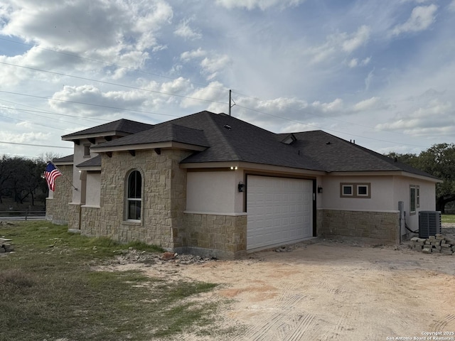 exterior space with a garage and central air condition unit