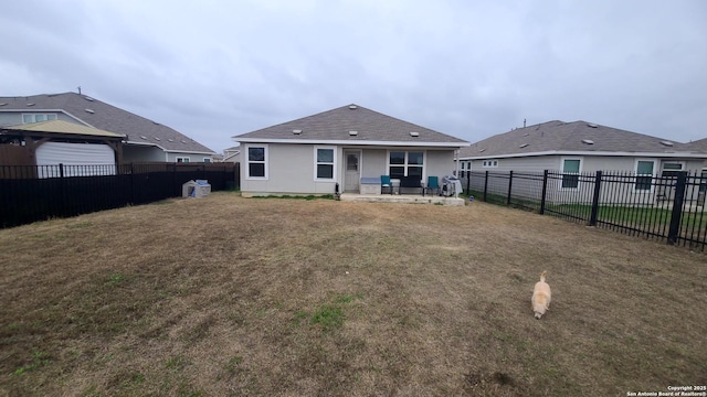 rear view of house featuring a patio and a yard