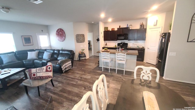 living room featuring sink and dark hardwood / wood-style floors