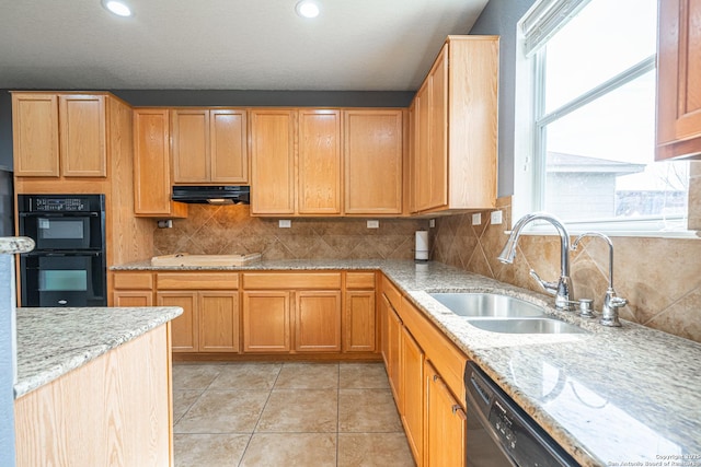 kitchen featuring light stone counters, black appliances, decorative backsplash, ventilation hood, and sink