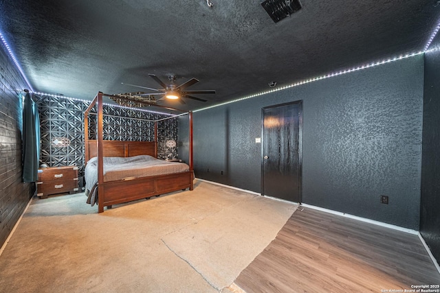 bedroom with hardwood / wood-style floors and a textured ceiling