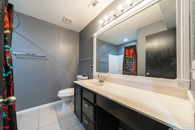 bathroom with toilet, a textured ceiling, walk in shower, tile patterned floors, and vanity