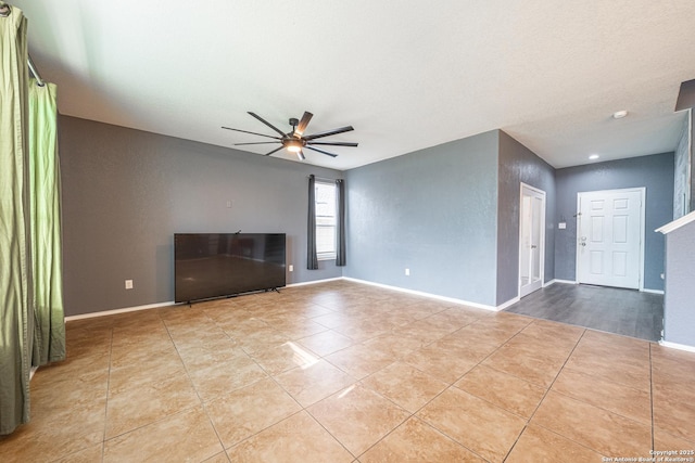 unfurnished living room featuring light tile patterned flooring and ceiling fan