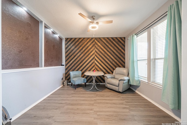 unfurnished room with ceiling fan and light hardwood / wood-style floors