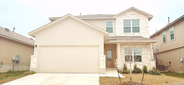 view of property with a garage and cooling unit