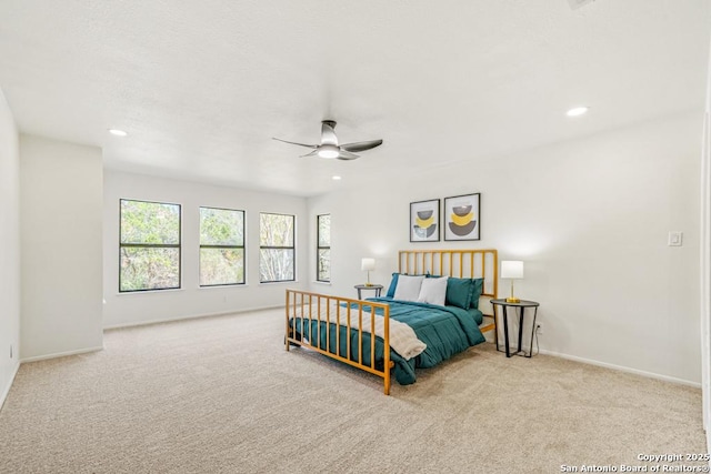 bedroom featuring light carpet and ceiling fan