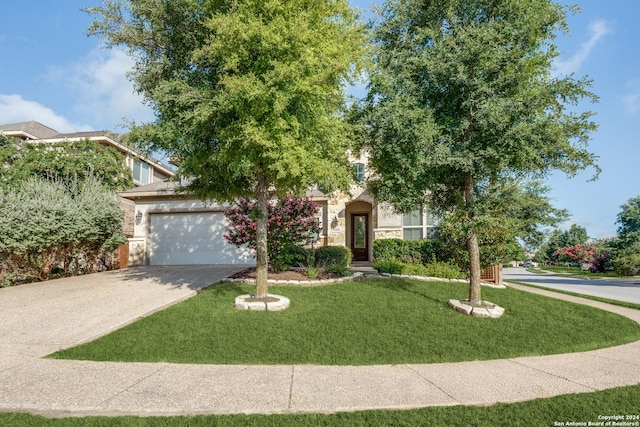 obstructed view of property featuring a front yard and a garage