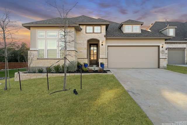 view of front of house with a garage and a lawn