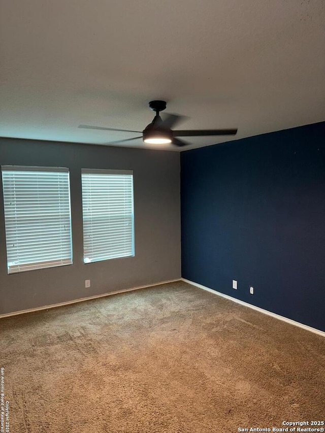 empty room featuring ceiling fan and carpet flooring