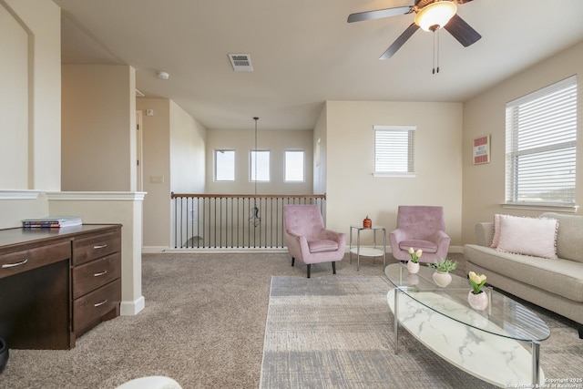 carpeted living room featuring ceiling fan