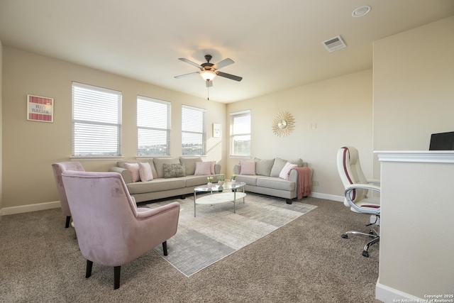 carpeted living room with ceiling fan