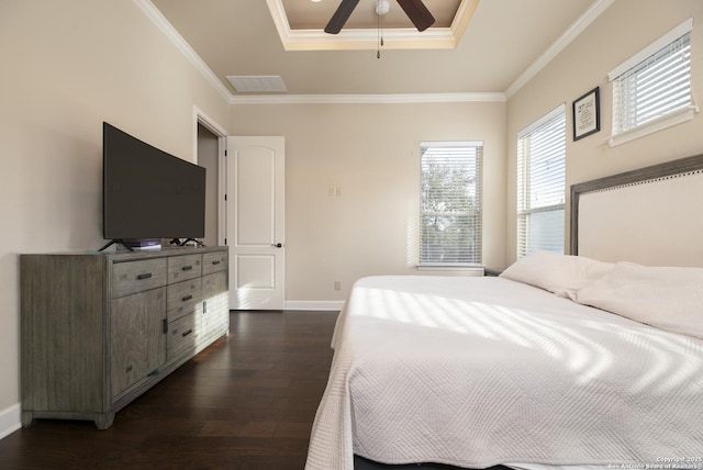 bedroom with a tray ceiling, ceiling fan, crown molding, and dark hardwood / wood-style flooring