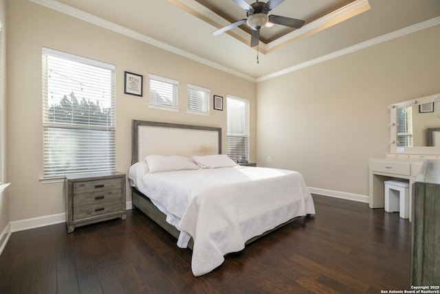 bedroom with a tray ceiling, ceiling fan, crown molding, and dark hardwood / wood-style flooring