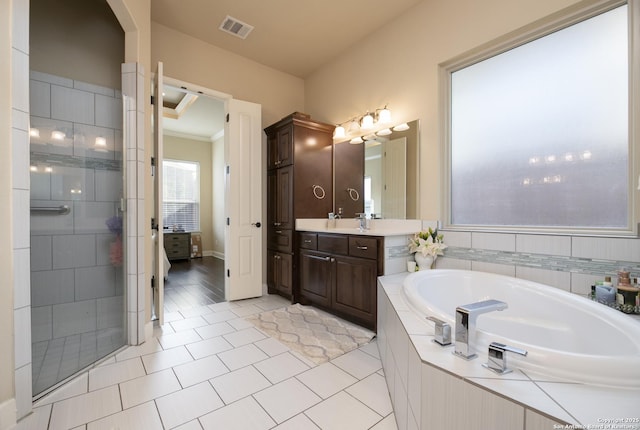 bathroom featuring vanity, independent shower and bath, and tile patterned floors