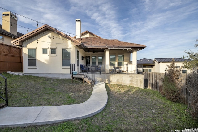 rear view of property with a yard