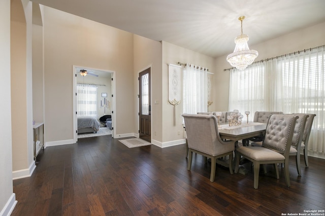 dining area with an inviting chandelier and dark wood-type flooring