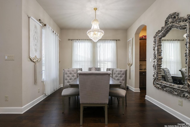 dining area featuring a chandelier, dark hardwood / wood-style floors, and a wealth of natural light