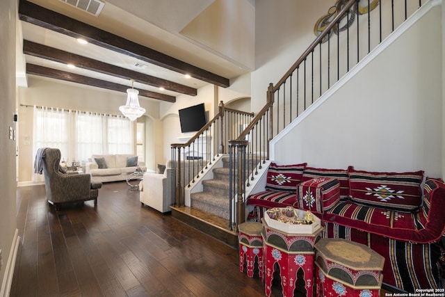 interior space with hardwood / wood-style flooring, beam ceiling, and a chandelier