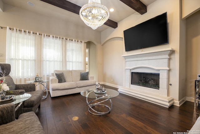 living room featuring a notable chandelier, dark hardwood / wood-style flooring, and beam ceiling