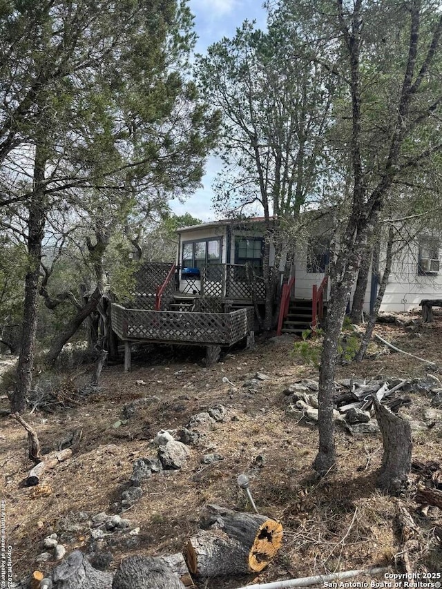 exterior space with a wooden deck and stairs