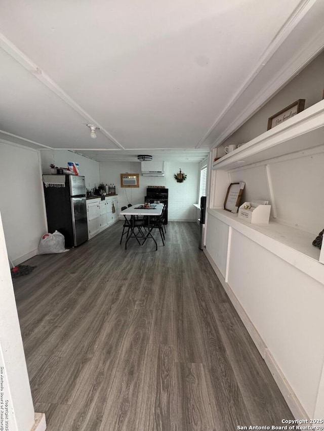 dining area featuring dark wood-type flooring and a wall mounted air conditioner