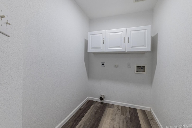 laundry room featuring cabinets, gas dryer hookup, dark hardwood / wood-style flooring, hookup for a washing machine, and electric dryer hookup