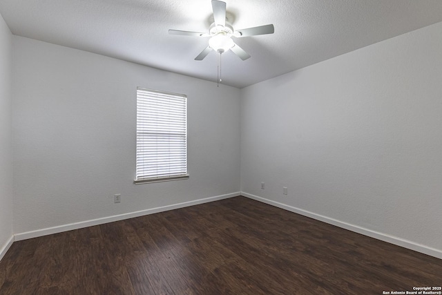 empty room featuring ceiling fan and dark wood-type flooring