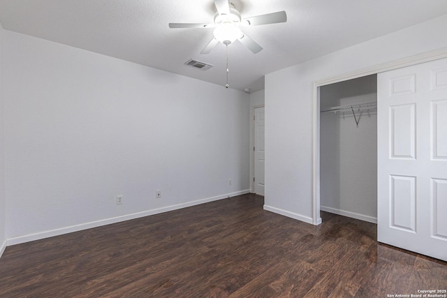 unfurnished bedroom featuring a closet, ceiling fan, and dark hardwood / wood-style floors