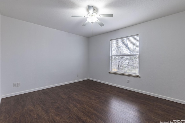 unfurnished room with ceiling fan and dark hardwood / wood-style flooring