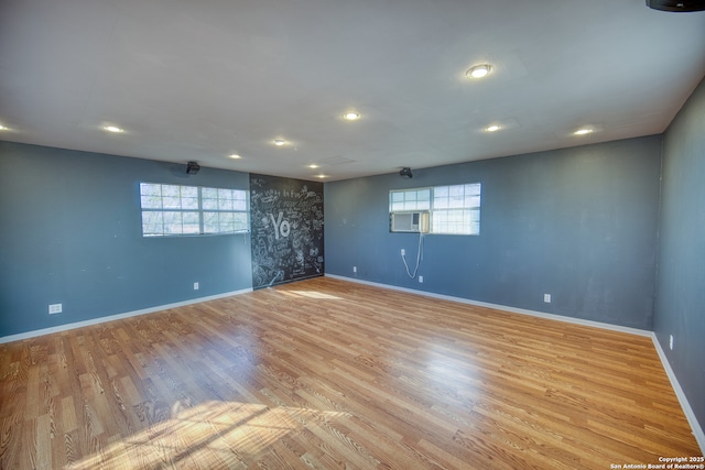 spare room with a healthy amount of sunlight and light hardwood / wood-style flooring