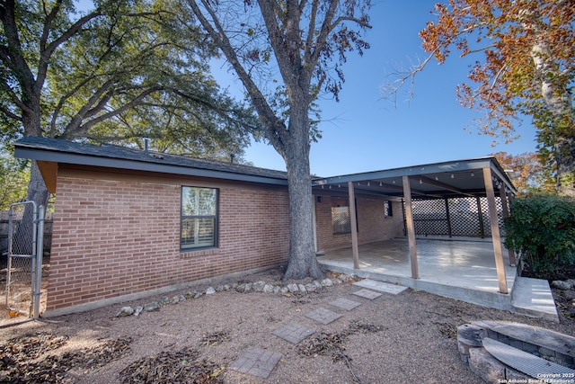 back of property featuring a carport