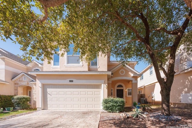 view of front of home featuring central air condition unit and a garage