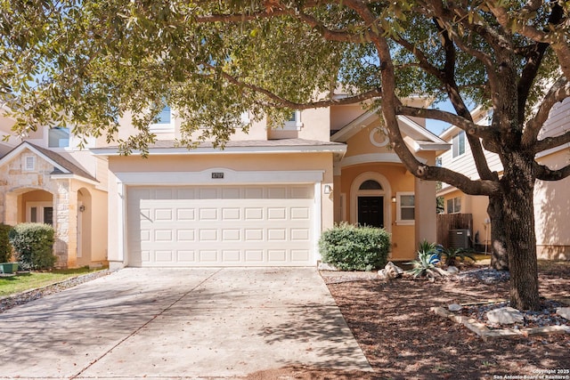 view of front of home with a garage and central AC unit