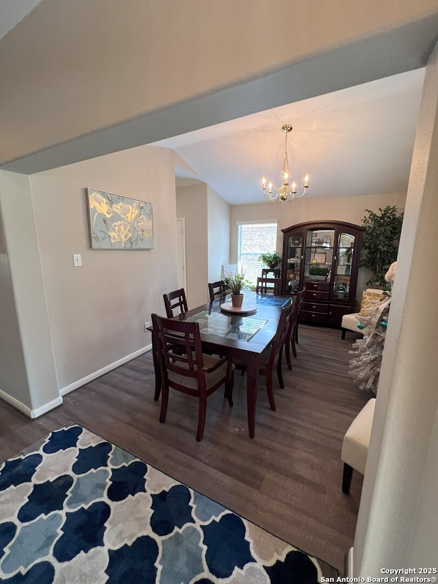 dining space with a notable chandelier and dark wood-type flooring