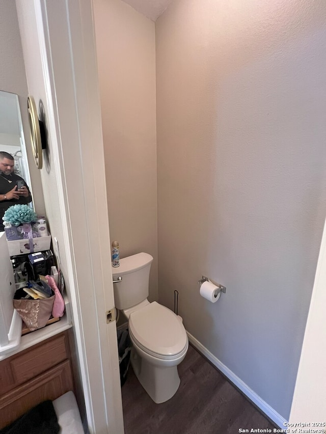 bathroom with wood-type flooring and toilet