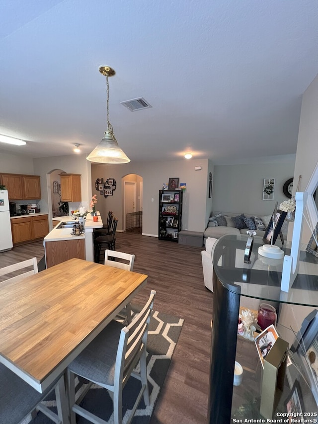 dining room with dark hardwood / wood-style flooring and sink