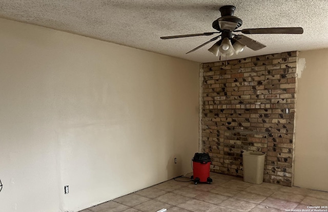 spare room featuring a ceiling fan and a textured ceiling