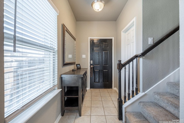 foyer entrance featuring light tile patterned flooring