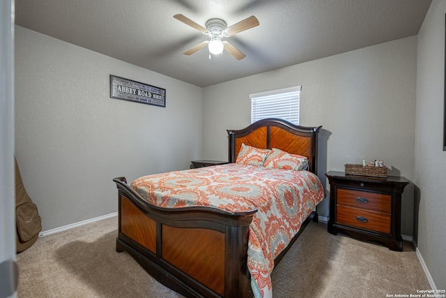 bedroom with a textured ceiling, carpet flooring, and ceiling fan