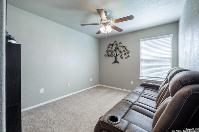 carpeted living room with ceiling fan and a textured ceiling