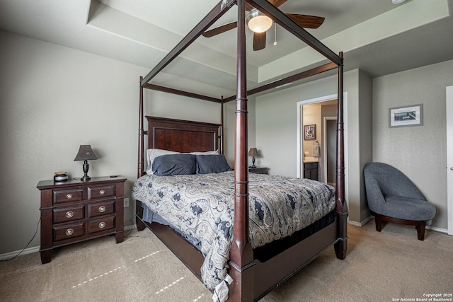 carpeted bedroom featuring ceiling fan and ensuite bath