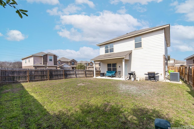 rear view of house with central air condition unit, a patio area, and a lawn